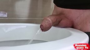 Uncut dick pissing in the toilet