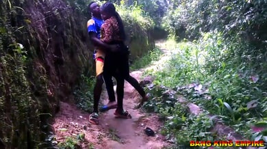 Dark-skinned woman in floral dress takes her lover in missionary position during forest encounter