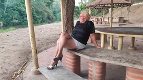 Beautiful mature woman with big crossed legs and dangling high heels (1)