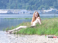 Playful blond nudist young caught on camera naked at the beach