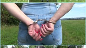 Handcuffed walk in a jeans jumpsuit