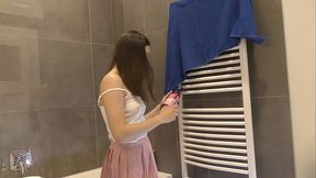 Braless hot brunette skinny and horny babe in a pink mini skirt to show her beautiful ass and legs in the bathroom