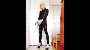 Crossdresser Faustine vinyl catsuit with necklace.