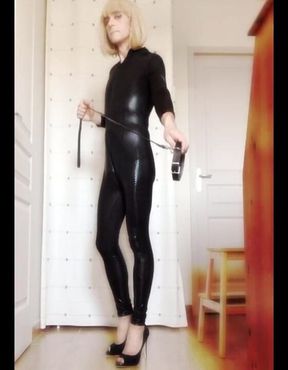 Crossdresser Faustine vinyl catsuit with necklace.