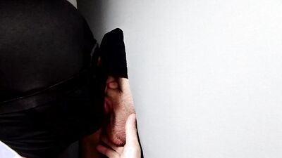 Gimp sucks a hard cock and deepthroats on it through a gloryhole.