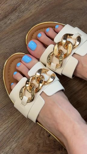 Woman in sandals with blue nail polish