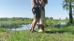 Passionate sex of a teen amateur couple by a summer lake outdoor