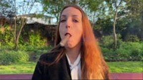 Liz Rainbow smoking a Flor de Oliva Cigar outdoors