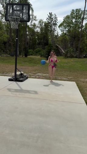 Woman playing basketball in backyard