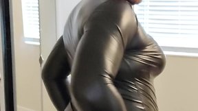 Maddy tries on black leather dress