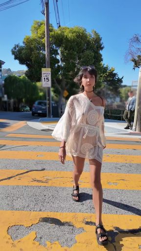 Woman in white dress crossing street