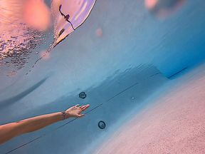 Carissa having a luau grass skirt dance underwater in a public pool (breast exposure, oh my!)