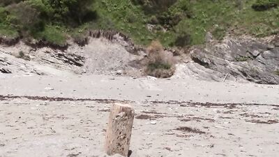 Two perverted dudes are having some fun on a public beach