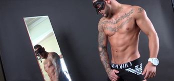 Masked stud showing off his muscular body in a sol