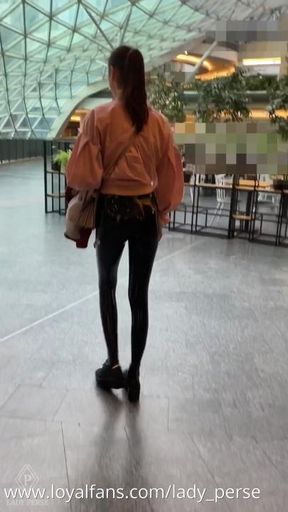 Public walk in city mall in latex leggings