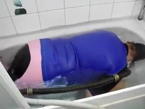 in pink jodhpur and gasmask in the bathtub