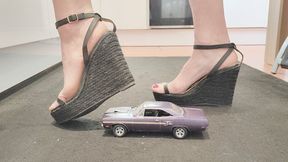 Giantess Raven Lee crushes a 1970 Plymouth GTX toy car in sexy black wedges with painted toenails close up ground view