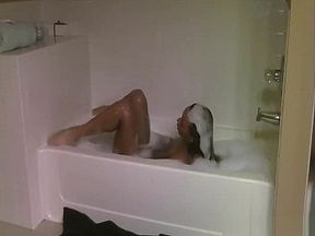 Skinny brunette MILF in a bikini showing her magnificent body