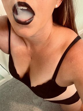 Sexy woman vapes in Black lipstick