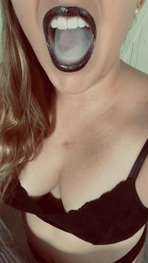 Sexy woman vapes in Black lipstick