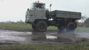 Crushing a bicycle by an old truck