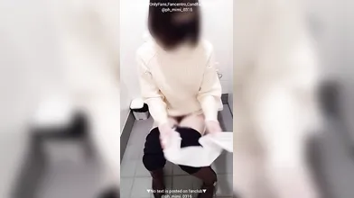 A Japanese woman jerks-off ensuing peeing inside a public restroom.