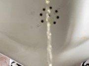 Pissing boy in a public toilet slow-mo