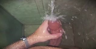 No hands water masturbation. Letting the stream of water fall on my big uncut Latino cock until it makes me cum.