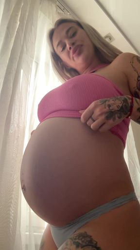 Pregnant belly gets attention to big tits