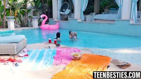 Petite teens play with each other's pussy in a pool