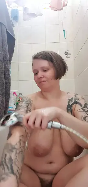 Sexy tattooed teen with big natural boobs massages her breasts in a bathtub