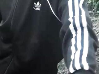 Cute Oriental homosexual twink in a ebony-and-white adidas tracksuit and Campus sneakers masturbates and cums outdoors