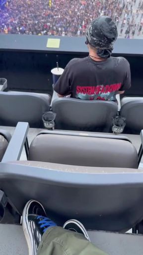 Man sitting in a box at a concert
