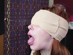 Blindfolded redhead slavegirl gagging cock