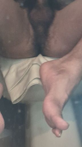 In the bathroom, naked rubbing my slippery brown dick with a glove