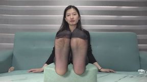 Domi dresses in black and wears stockings