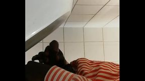 Black gay guy at public urinal stroking cock