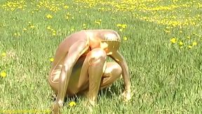 Sexy ebony babe in skintight golden spandex catsuit posing outdoor
