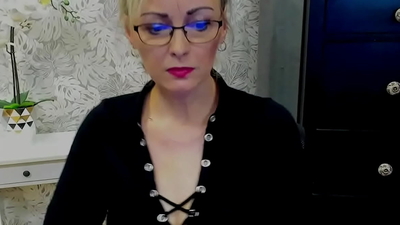 Blonde amateur German MILF LUXvanessa in mini skirt and black blouse with big cleavage flashing boobs on solo webcam show