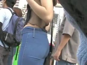 Candid cam of a smoking hot brunette in tight blue jeans