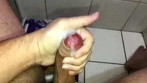 Quick Handjob Leads to Intense Cumshot in Bathroom Stall