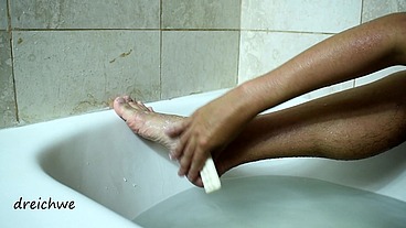 Feet warm in a bathtub with soap