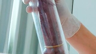 Putting on latex medical gloves while pumping a penis