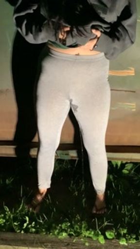 Girl pees in her yoga pants behind dumpster