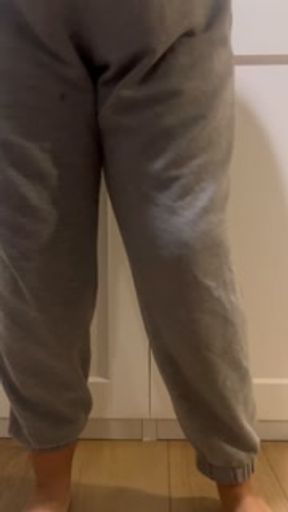 Desperately peeing my sweatpants and making a mess all over the floor