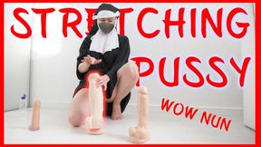 The nun tests the dildo, stretches the pussy