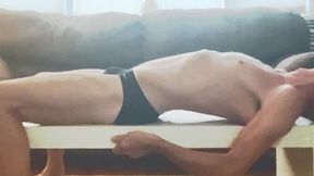 retro september 6, 2021 stretching in tight speedo underwear briefs on table in living room