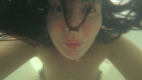 Blowing bubbles underwater in the bathtub Baa