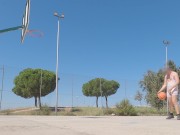 Sweaty basketball in tight singlet on public field
