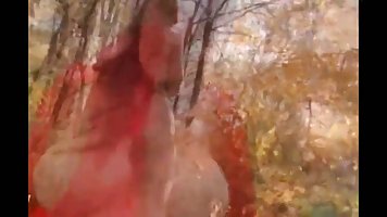 Charming girl in a sexy, red dress is about to get fucked in the forest